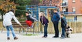 Children playing rubber band jumping game and laughing