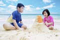 Children playing sand at coast Royalty Free Stock Photo