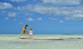 Children playing on a sandbank in the ocean. Royalty Free Stock Photo