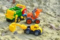 Children playing in the sandbox sandpit, kids with toy car vehicle, playground in kindergarten day care Royalty Free Stock Photo