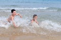 Children playing in sea waves Royalty Free Stock Photo