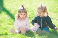 Children playing sitting on green grass in spring park. Children in beautiful spring green field. Brother and sister Royalty Free Stock Photo