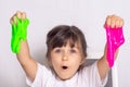 Child playing with slime. Kids squeeze and stretching slime.
