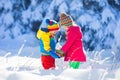 Children playing in snowy winter park