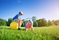 Children are playing on the sport field with hula hoop and rubber fitness ball Royalty Free Stock Photo