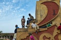 Children playing at a statue in the Praca dos Herois Nacionais, in Guinea-Bissau