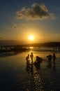 Children playing at sunset on the beach Royalty Free Stock Photo