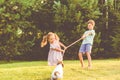 Children playing with their family pet dog tug of war game Royalty Free Stock Photo