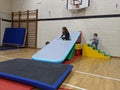 Children playing on top of their base made from soft play equipment