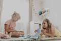 Children playing with toy building blocks on the floor at home or kindergarten Royalty Free Stock Photo