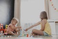 Children playing with toy building blocks on the floor at home or kindergarten Royalty Free Stock Photo