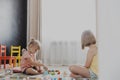 Children playing with toy building blocks on the floor at home or kindergarten Royalty Free Stock Photo