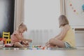 Children playing with toy building blocks on the floor at home or kindergarten Royalty Free Stock Photo