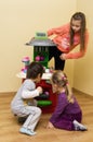 Children playing with toy cooker