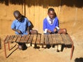 Children playing traditional xylophone