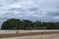 Children playing in the tropical beach on a cloudy day. Ko Lanta, Krabi, Thailand