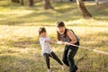 Children playing tug of war at the park on sunsut Royalty Free Stock Photo