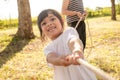 Children playing tug of war at the park on sunsut Royalty Free Stock Photo