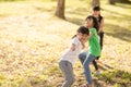 Children playing tug of war at the park on sunsut Royalty Free Stock Photo