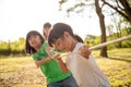 Children playing tug of war at the park on sunsut Royalty Free Stock Photo