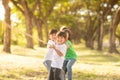 Children playing tug of war at the park on sunsut Royalty Free Stock Photo