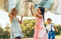 Children playing under the blanket, jumping and dancing together. Happy little boy and little girls enjoying summer day in the Royalty Free Stock Photo