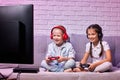 children playing video game with game console Royalty Free Stock Photo