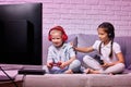 children playing video game with game console Royalty Free Stock Photo