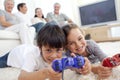Children playing video games and family on sofa Royalty Free Stock Photo