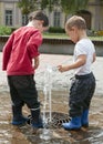 Children Playing With Water Fountain