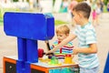 Children playing whack a mole arcade game at an amusement park Royalty Free Stock Photo