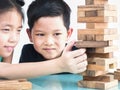 Children are playing a wood blocks tower game