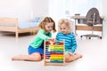 Kids playing with wooden abacus. Educational toy. Royalty Free Stock Photo