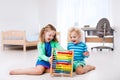 Kids playing with wooden abacus. Educational toy. Royalty Free Stock Photo