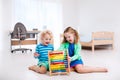 Kids playing with wooden abacus. Educational toy. Royalty Free Stock Photo