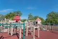 Children playing at wooden playground recreation area in American public park Royalty Free Stock Photo