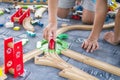 Children playing with wooden train. Toddler boy play with train and cars. Educational toys for preschool and kindergarten child. Royalty Free Stock Photo