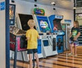 Children plays fighting game on arcade machine. Moby ferry ship