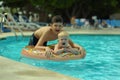 Children at pool, happiness and joy. Two brothers having fun swimming ring Royalty Free Stock Photo