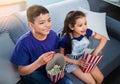 Children, popcorn and television or excited in home for movie entertainment as siblings, subscription or eat. Boy, girl