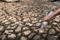 Children pour water on the arid ground. Royalty Free Stock Photo