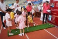 Children practice golf