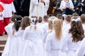 Children prepared for the first communion are waiting in front of the church