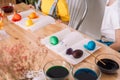 Children preparing for Easter paint eggs in different colors