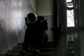 Children problem, young kid sit on stairs on abandoned building f