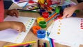 Children putting colorful dots on paper with fingers, painting a picture Royalty Free Stock Photo