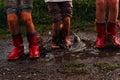 Children after the rain with rubber boots