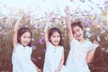 Children raise hands and playing together in the cosmos flower