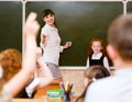 Children raising hands knowing the answer to the question