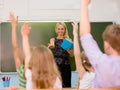 Children raising hands knowing the answer to the question